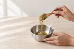 Digestive Wellness Blend powder being lifted on a wooden spoon