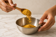 Golden Moon Latte powder being lifted on a wooden spoon