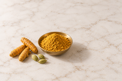 Golden Moon Latte powder close up in a shallow brass dish