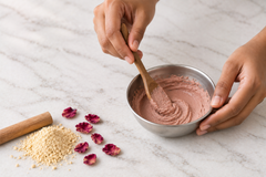 Radiance Face Mask powder being lifted on a wooden spoon